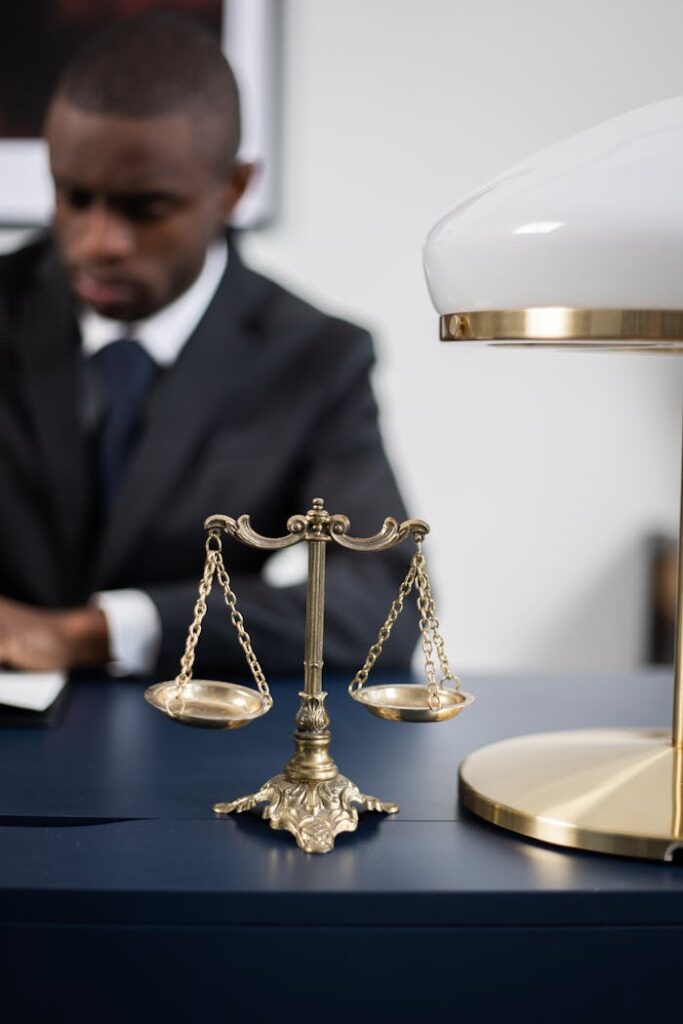 Brass Colored Balance Scale on a Lawyers Table